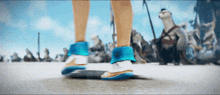 a person wearing a pair of blue and white shoes is riding a skateboard .
