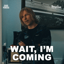 a man says wait i 'm coming in front of a sign that says hulu