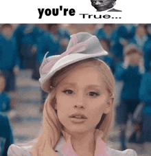 a woman wearing a white hat with the words you 're true behind her