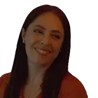 a woman wearing earrings and a necklace is smiling
