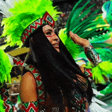 a woman in a colorful costume with rio on the bottom right