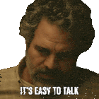 a man with curly hair and a beard has the words it 's easy to talk on his face