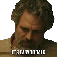 a man with curly hair and a beard has the words it 's easy to talk on his face