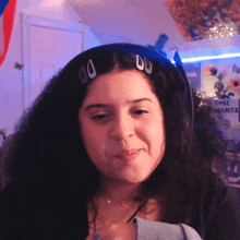 a woman wearing a pair of headphones with the letter d on her headband