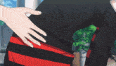 a person 's hand is on another person 's back