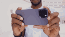 a man is taking a picture with an apple iphone