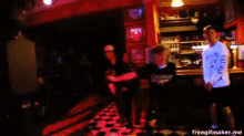 a blurry picture of people dancing in a bar with the words freegifmaker.me at the top