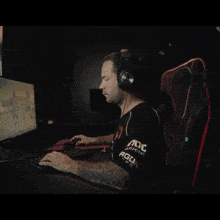a man wearing headphones looks at the camera