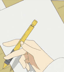 a hand is holding a yellow object with a black stripe on the handle