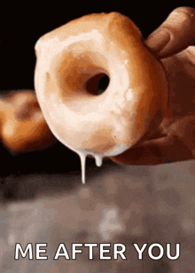 a person is holding a donut with icing dripping out of it with the words me after you written below it