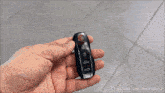 a green car is driving on a tiled floor with youtube.com in the corner
