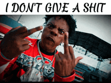 a man giving the middle finger with the words " i don t give a shit " below him