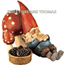 a gnome is eating blackberries next to a mushroom .