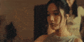 a woman is standing in front of a mirror looking at herself in a mirror .