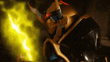 a black and gold robot with a yellow light coming out of it