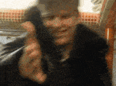 a blurry picture of a man talking on a telephone