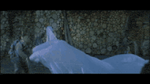 a man in a gas mask is standing next to a large piece of ice