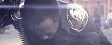 a close up of a police officer wearing a helmet and bullet belt