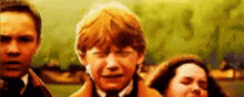a group of people are standing next to each other and one of the children is crying .