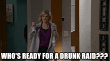 a woman is holding a bottle of vodka and says " who 's ready for a drunk raid "