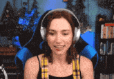 a woman wearing headphones is sitting in a chair