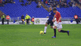 two soccer players on a field with one wearing number 25
