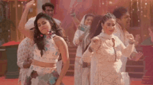 a group of women are dancing together in a room .