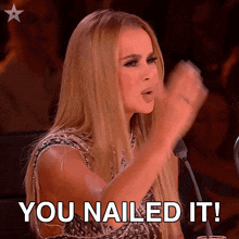a woman is giving a thumbs up with the words you nailed it behind her