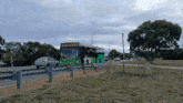 a green and white bus with school bus 001 on the front