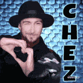 a man in a fedora making a heart with his hands and the word chen behind him