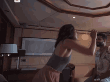 a man and a woman are dancing in a room with a watermark that says ' inongvisc ' on the bottom