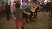 a group of men are playing guitars in front of a sign that says " welcome "