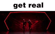 two bald men are standing in front of a red light and the words `` get real '' are on the bottom .