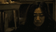 a woman is crying with a tear coming out of her eye .