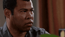 a man with sweat running down his face looks at the camera