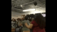 a blurry picture of a group of people dancing in a room