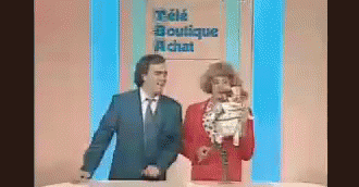 a man and a woman are standing in front of a sign that says tele boutique chat