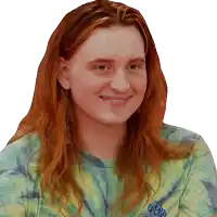 a woman with red hair is wearing a tie dye t-shirt