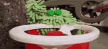 a picture of a steering wheel with a green object on top of it