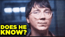 a close up of a man wearing glasses with the words `` does he know '' above him
