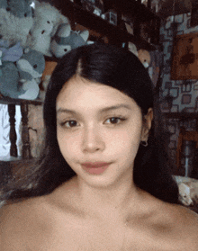 a girl with a necklace on her neck looks at the camera