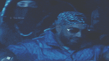 a man wearing sunglasses and a bandana has the name the maw on the bottom right corner