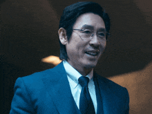 a man in a suit and tie is smiling