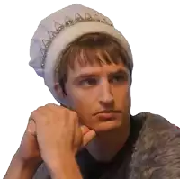 a young man wearing a white hat with a tiara on his head