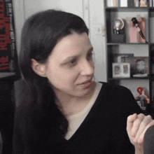 a woman wearing a black shirt is looking at something