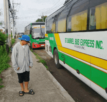 a man is standing next to a bus that says st. gabriel bus express inc.