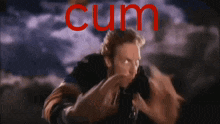 a man with the word cum written in red behind him