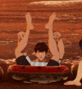 a man is laying on his back in a raft with his legs in the air .