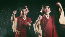a man in a red kimono is holding a mask with chinese writing behind him