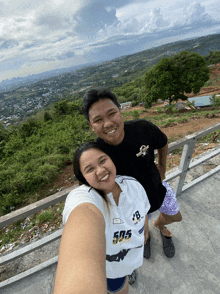 a man and a woman are posing for a picture and the woman is wearing a shirt with 505 on it